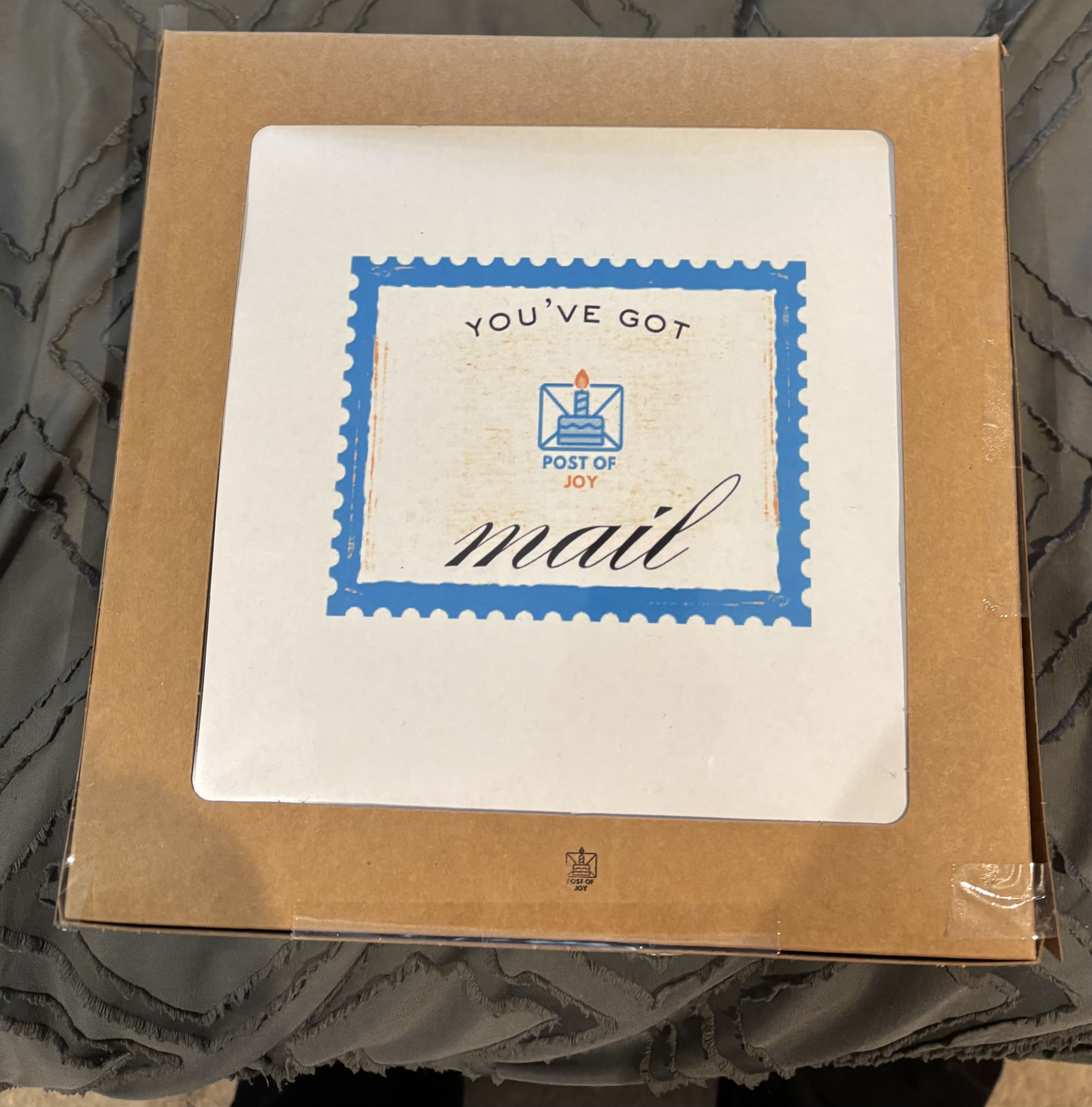 A Post of Joy delivery box with a branded birthday mail label.